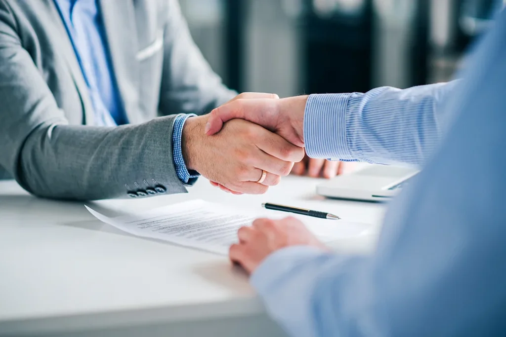 businessmen-handshaking-signed-contract