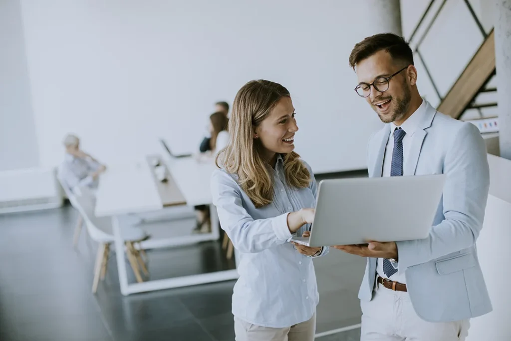young-business-couple-working-discussing-by-laptop-office-front-their-teamcopy